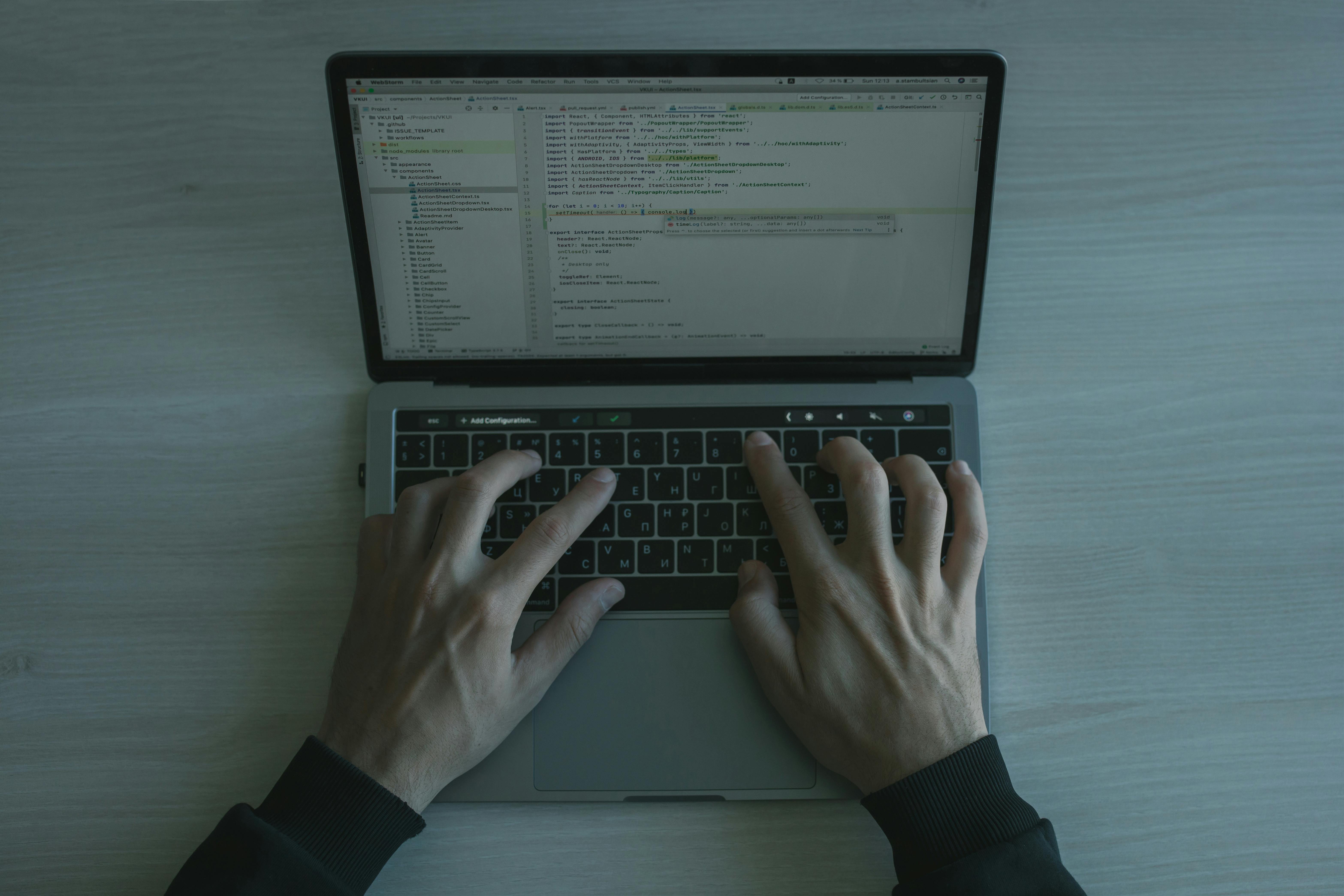 Person typing on laptop.